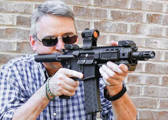 man shooting a rifle-caliber handgun