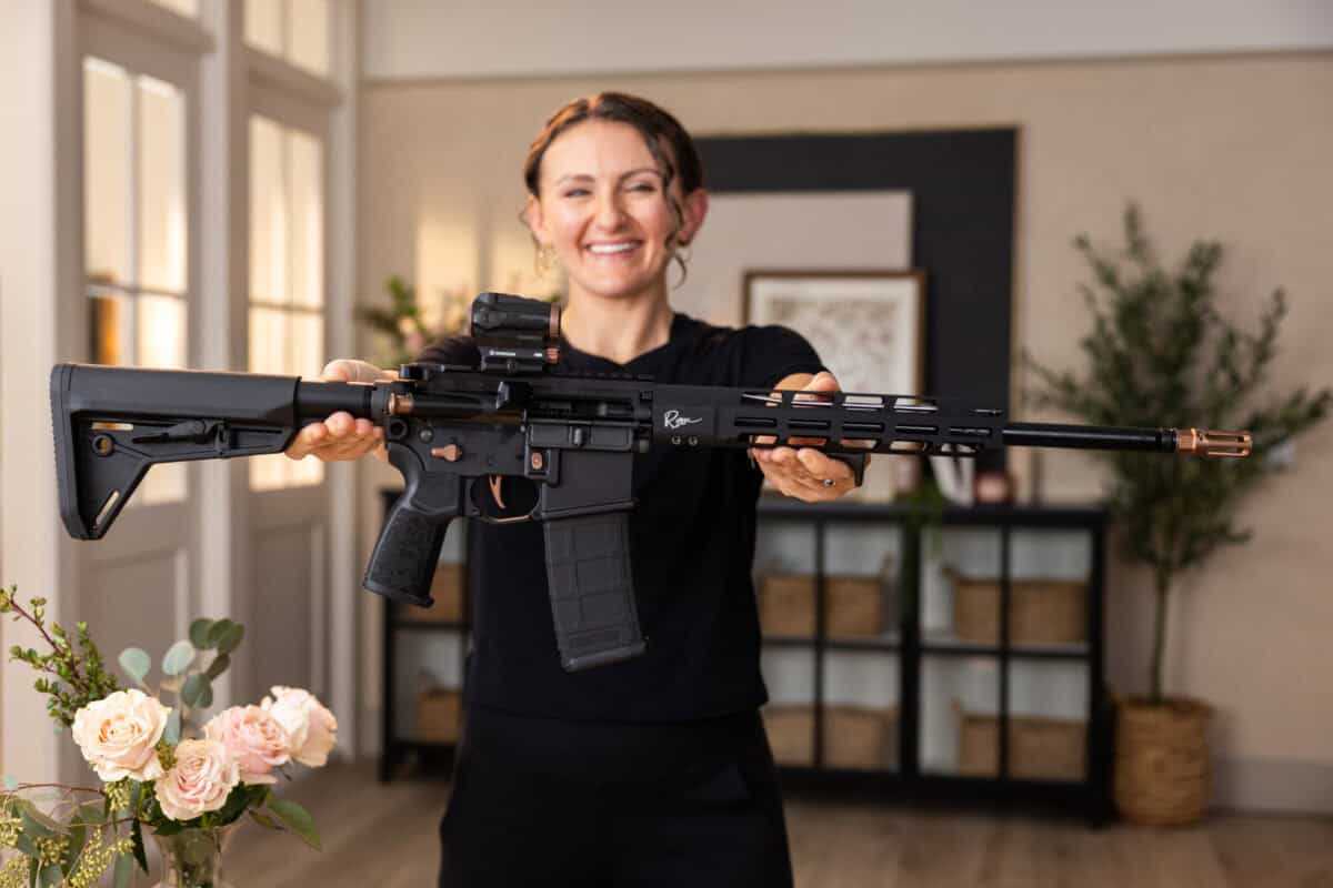 Lena Miculek holding SIG SAUER M400 Rose rifle